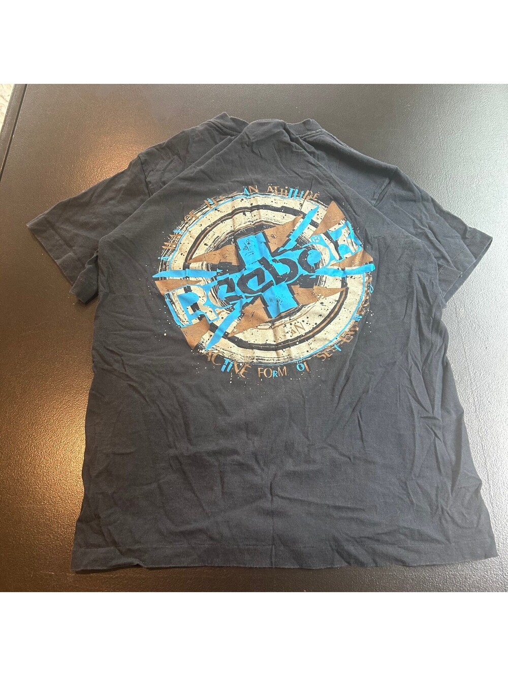 Vintage 90s surf Reebok Black Graphic T-Shirt with Blue and Brown Logo